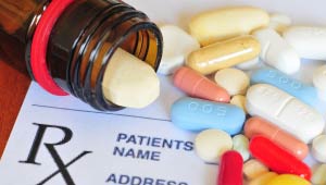 A picture of a pill bottle, pills on a table, and an Rx script.