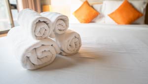 A picture of a hotel bed and hotel towels.